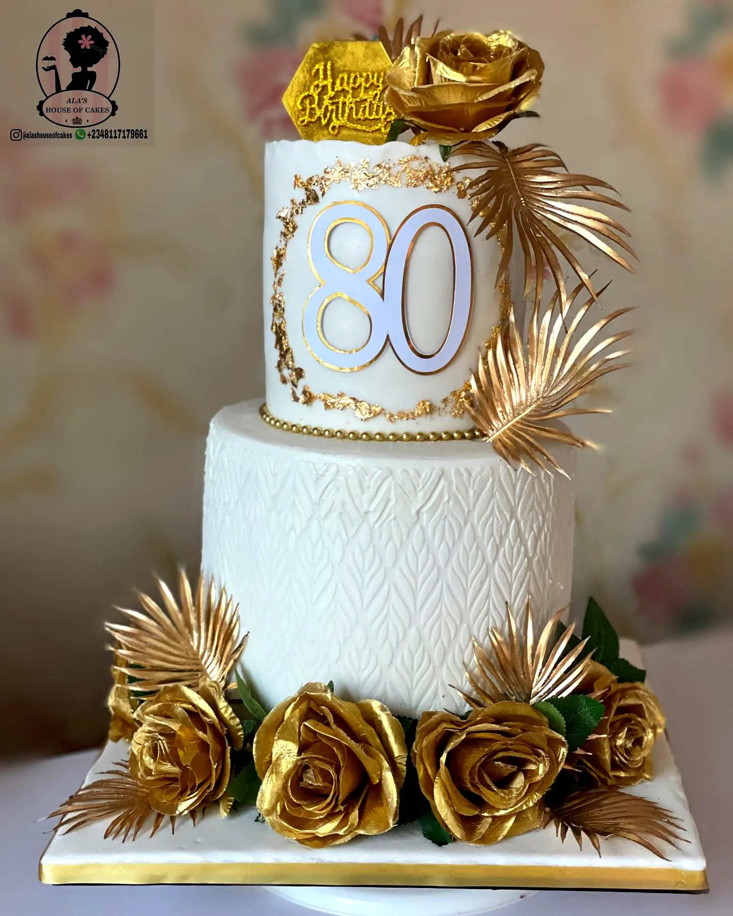 Elegant 80th Birthday Cake Design in Gold and White with Floral Accents