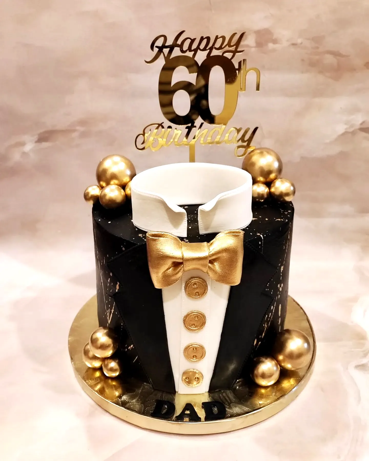 Elegant Black and Gold Tuxedo Cake for a Mans 60th Birthday Celebration