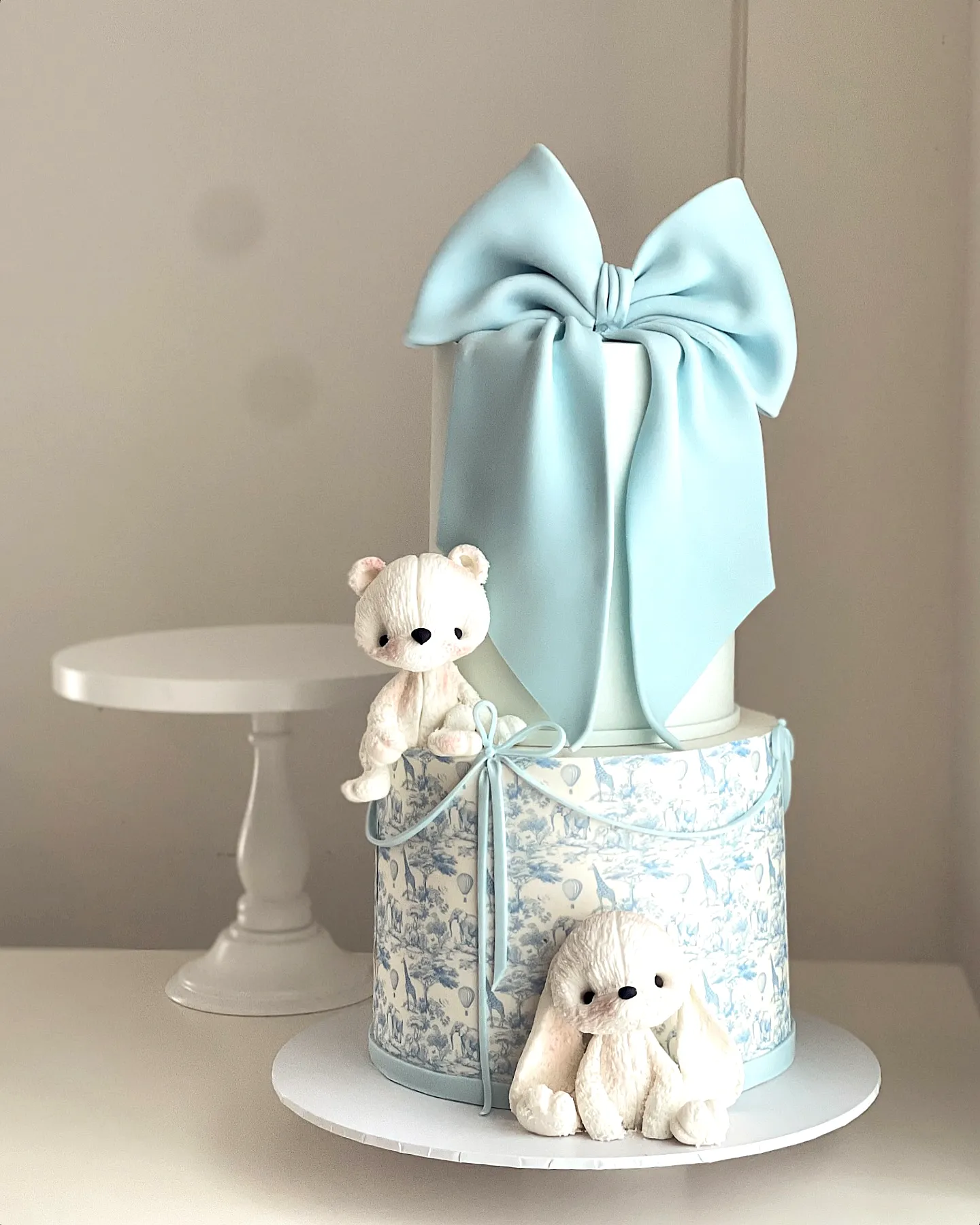 Elegant Blue Birthday Cake Design with Whimsical Touches and Adorable Figures