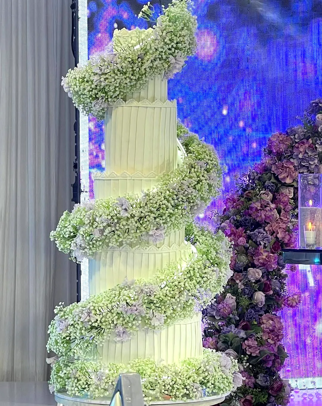 Elegant contemporary wedding cake design with fresh floral accents