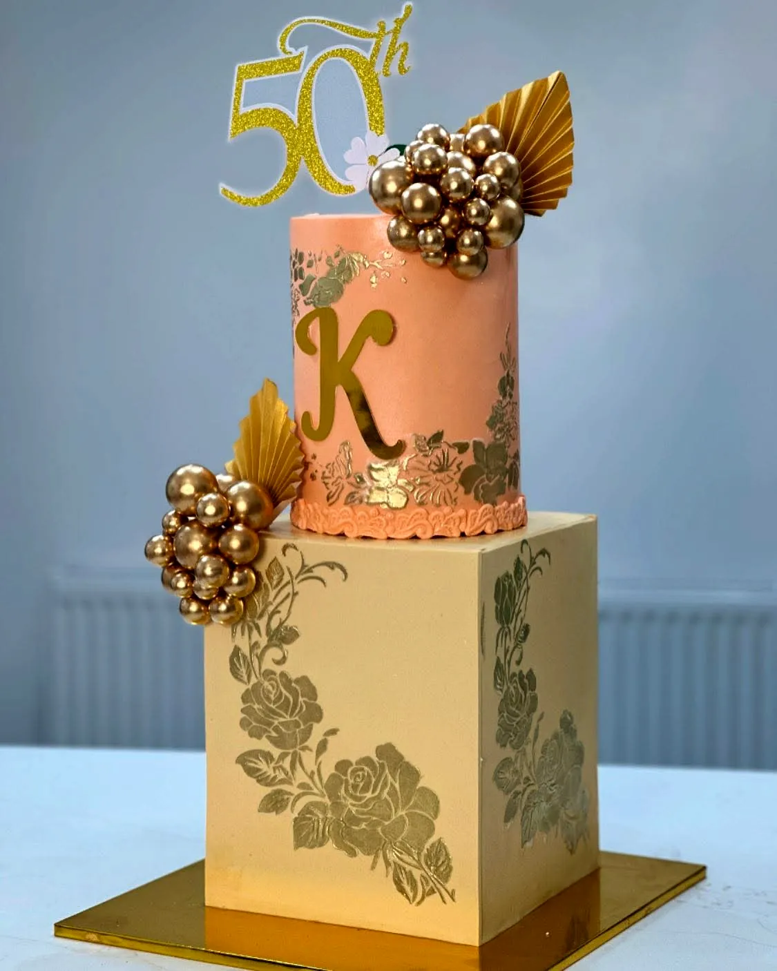 Elegant golden birthday cake design with floral patterns and luxurious touches
