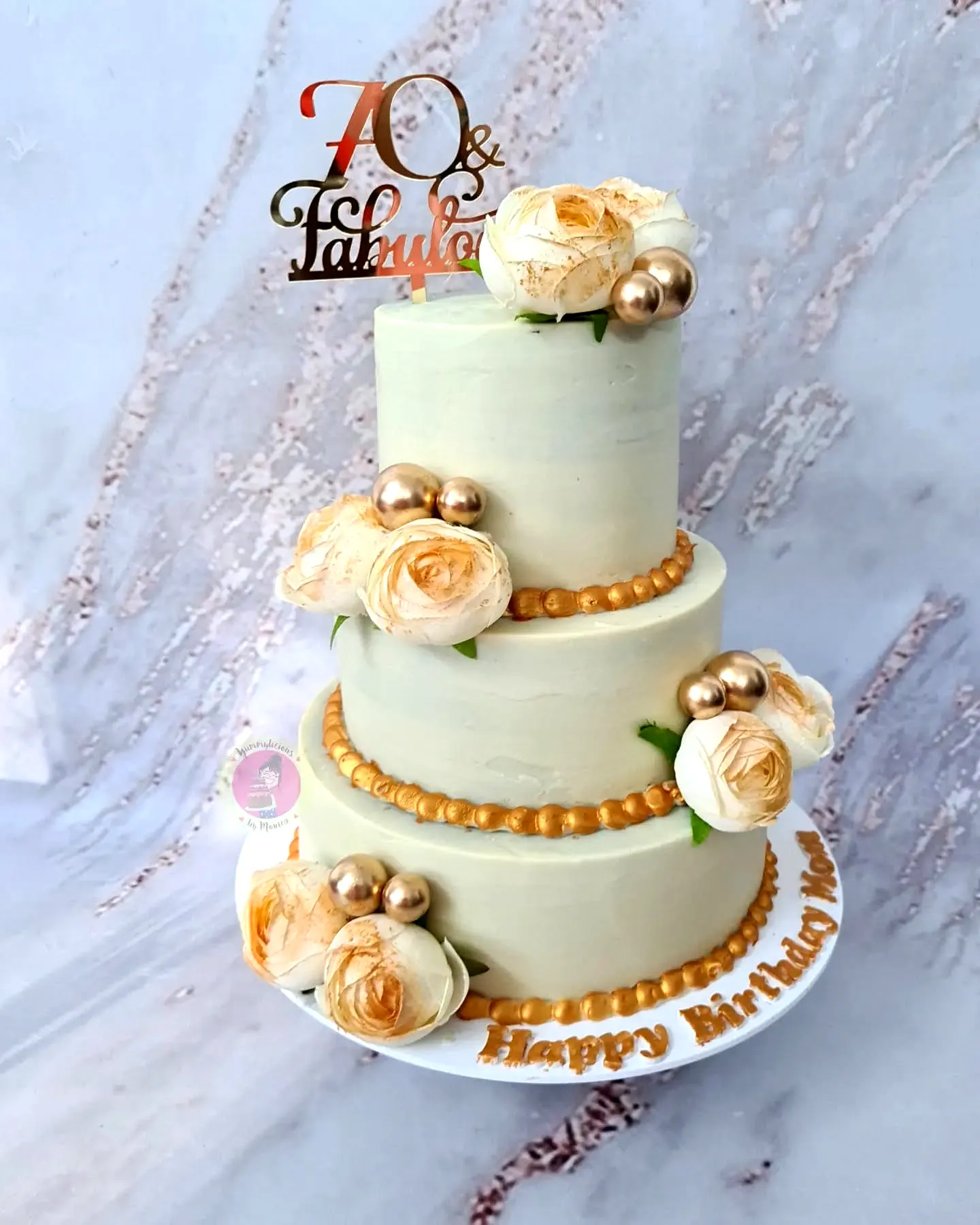 Elegant mint green 70th birthday cake design with gold accents and roses