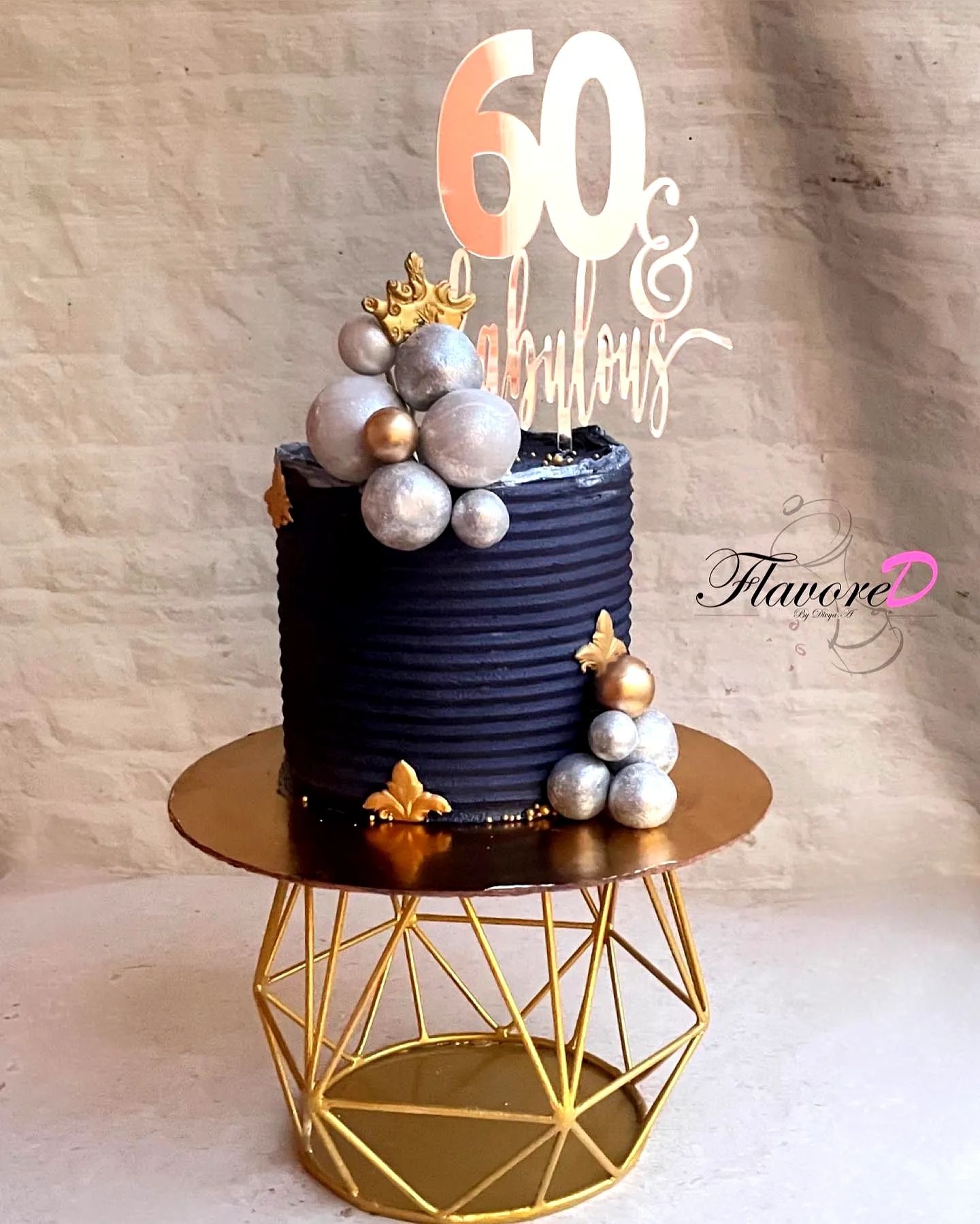 Elegant navy blue 60th birthday cake for a man with gold accents