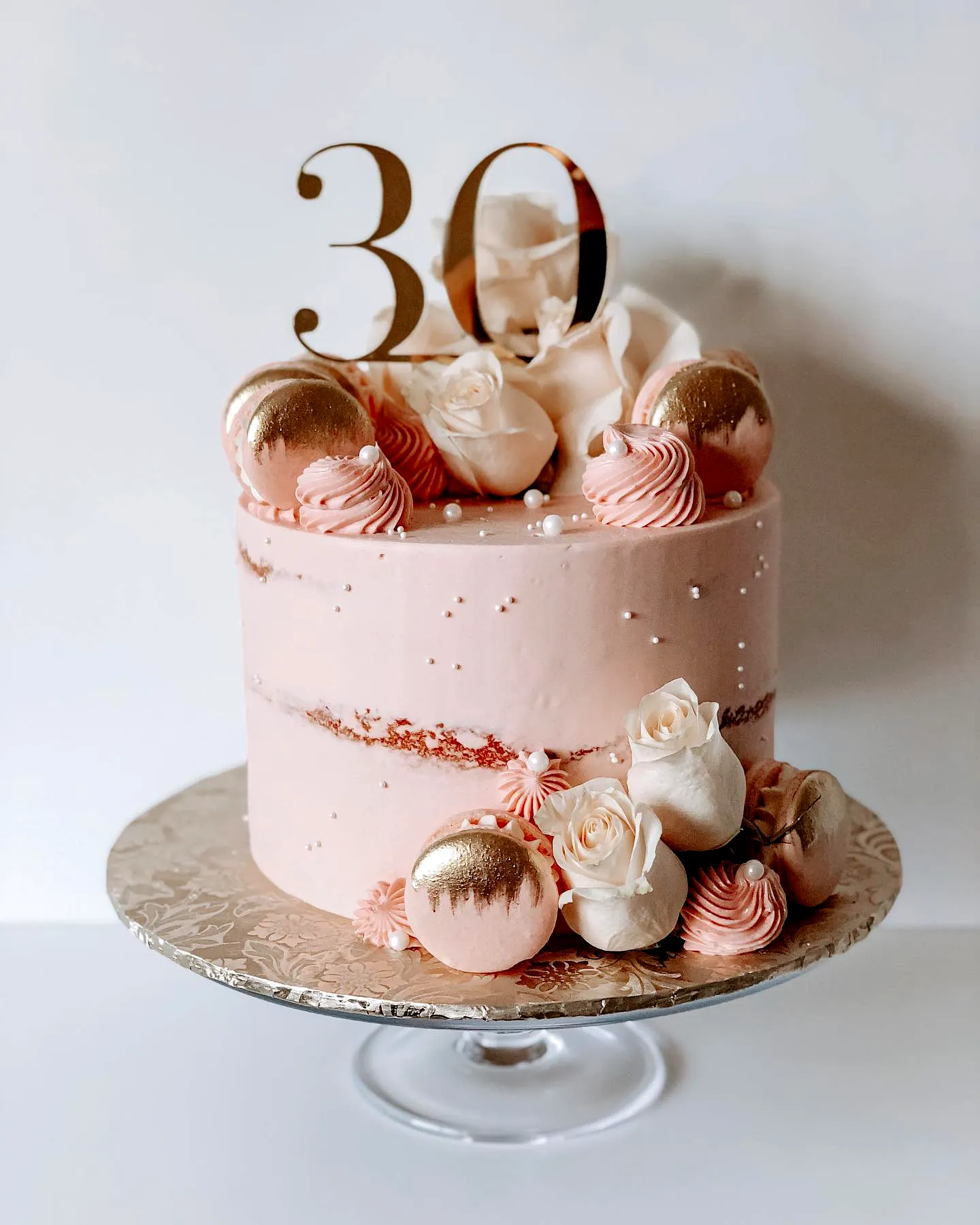 Elegant pink buttercream cake for a chic 30th birthday celebration
