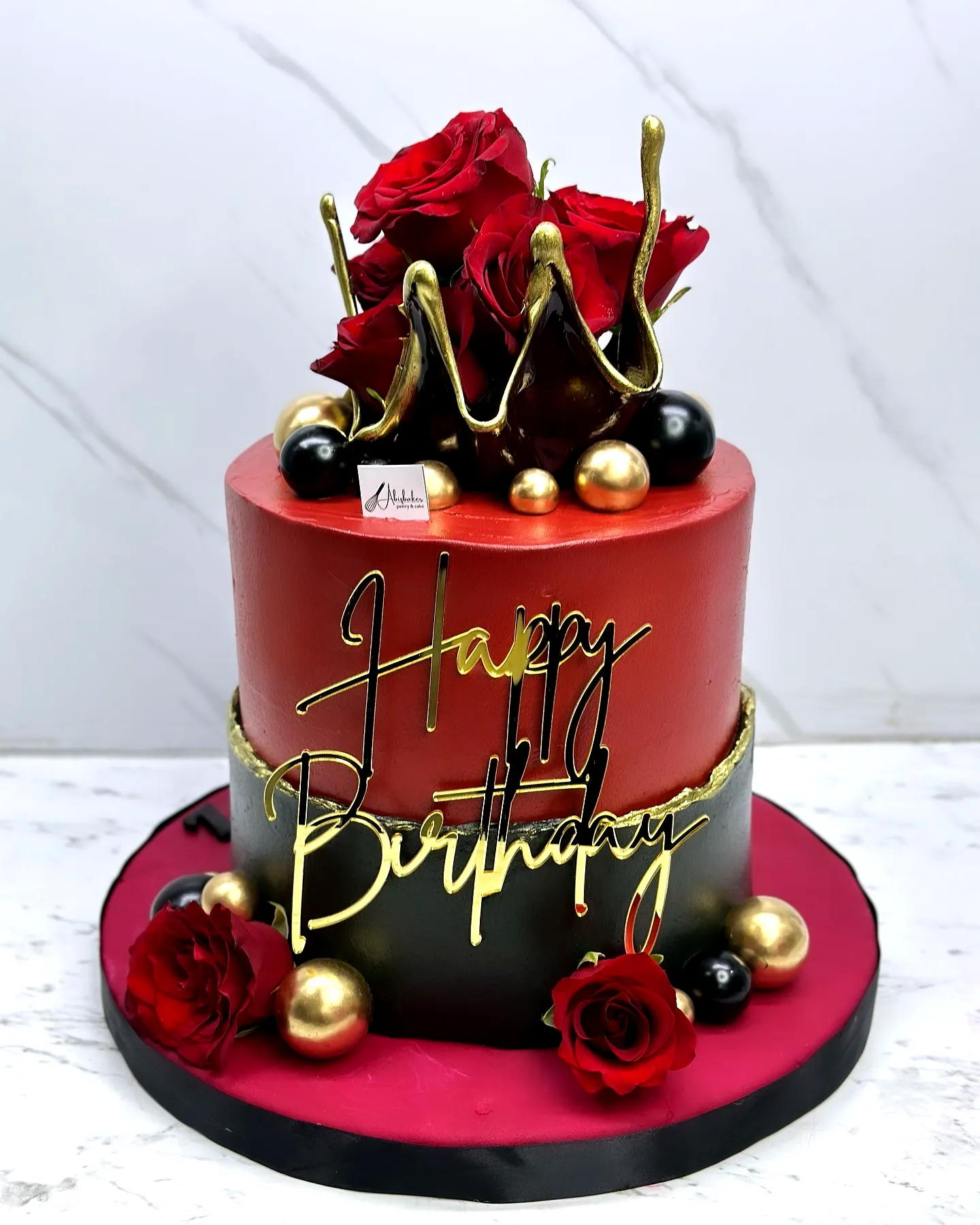 Elegant Red and Black Birthday Cake for a Regal Celebration