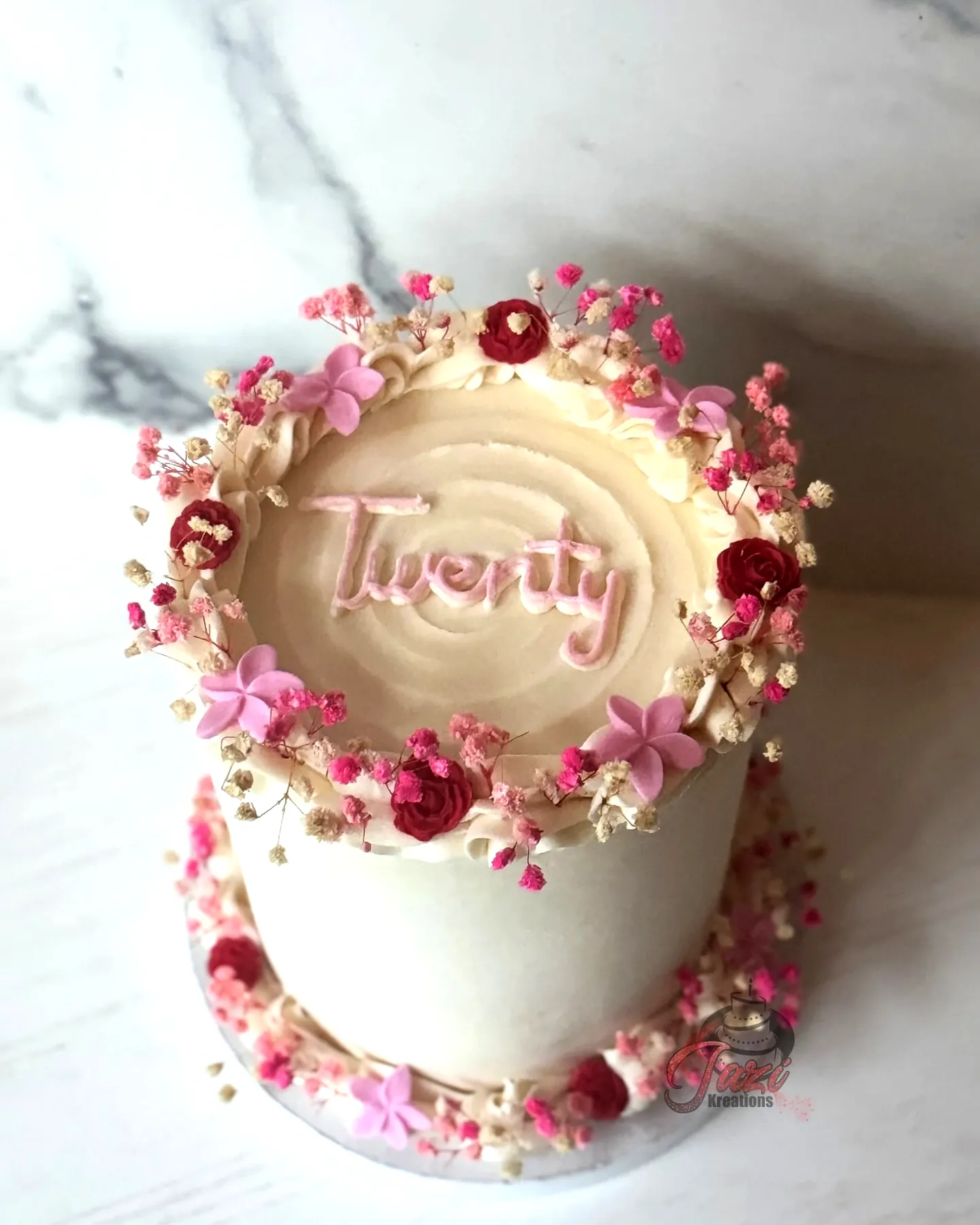 Elegant two-tiered buttercream cake for a stunning 20th birthday celebration