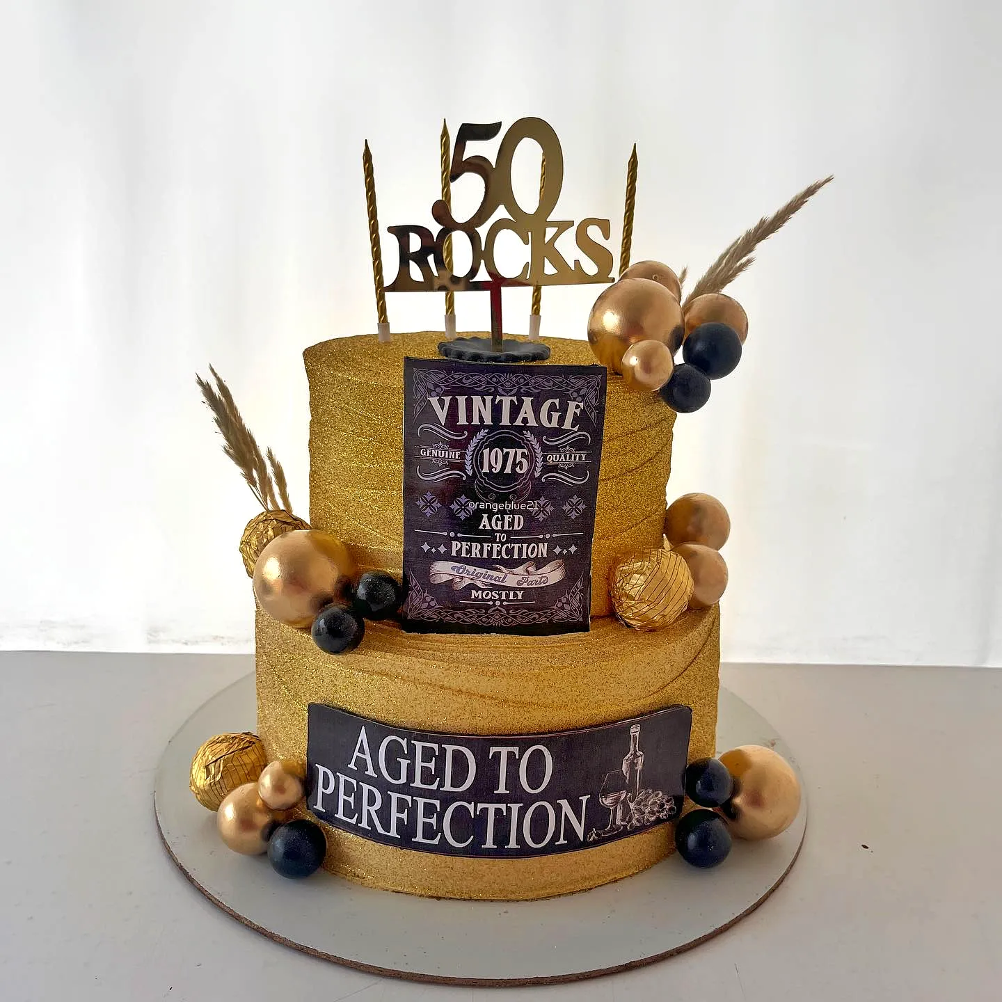 Elegant vintage 50th birthday cake for men in gold and black design