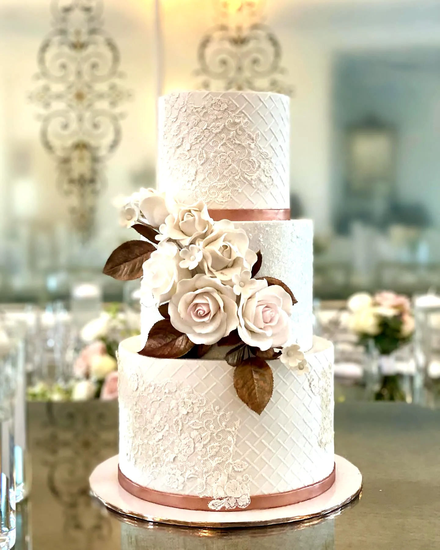 Elegant wedding cake design with delicate lace and pastel hues