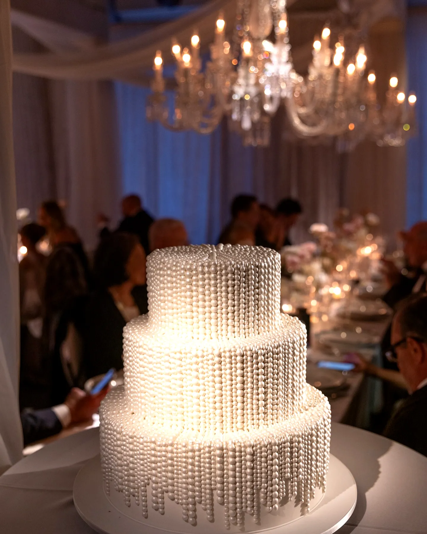 Elegant wedding cake design with luxurious pearl decorations and smooth frosting