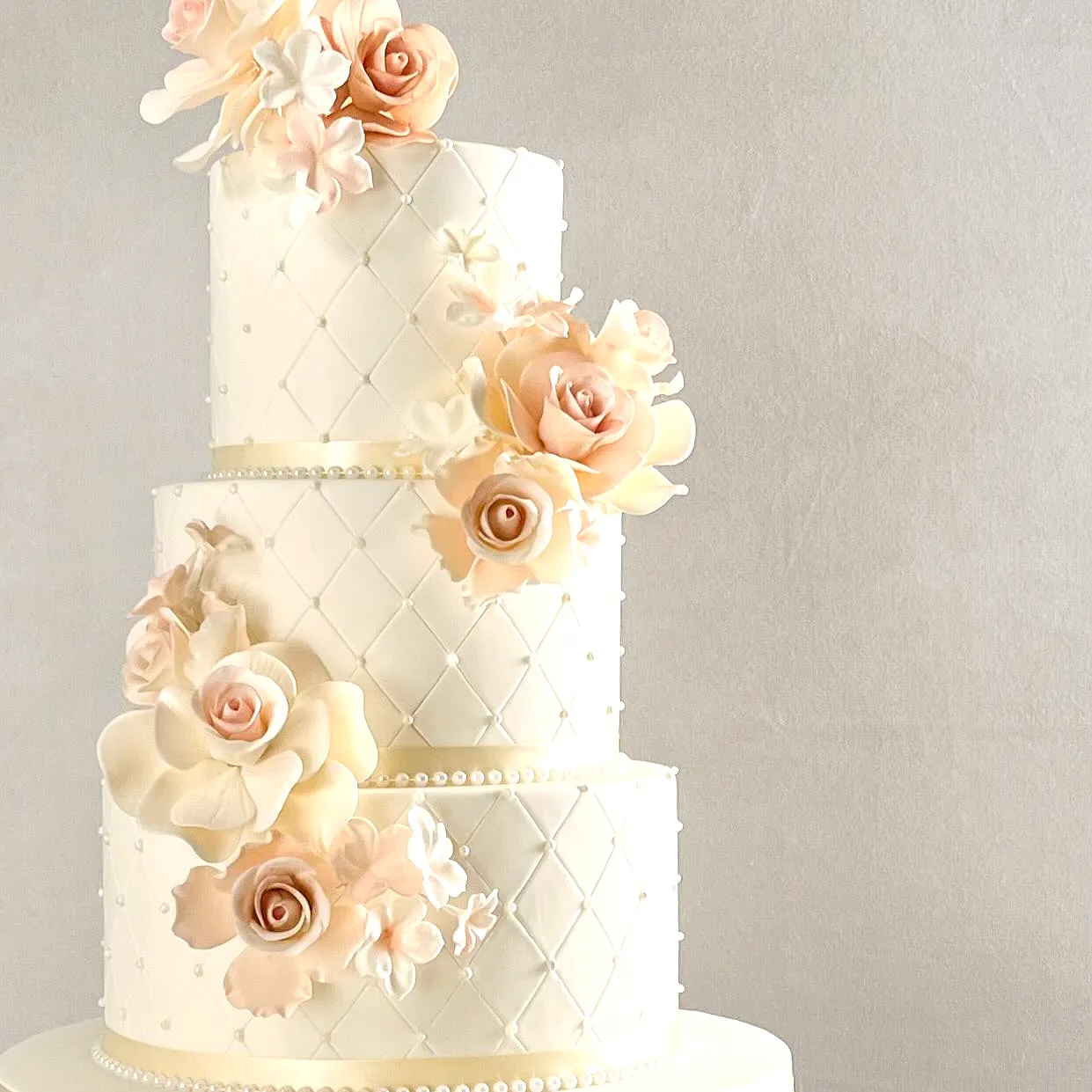 Elegant wedding cake design with quilted texture and watercolor flowers