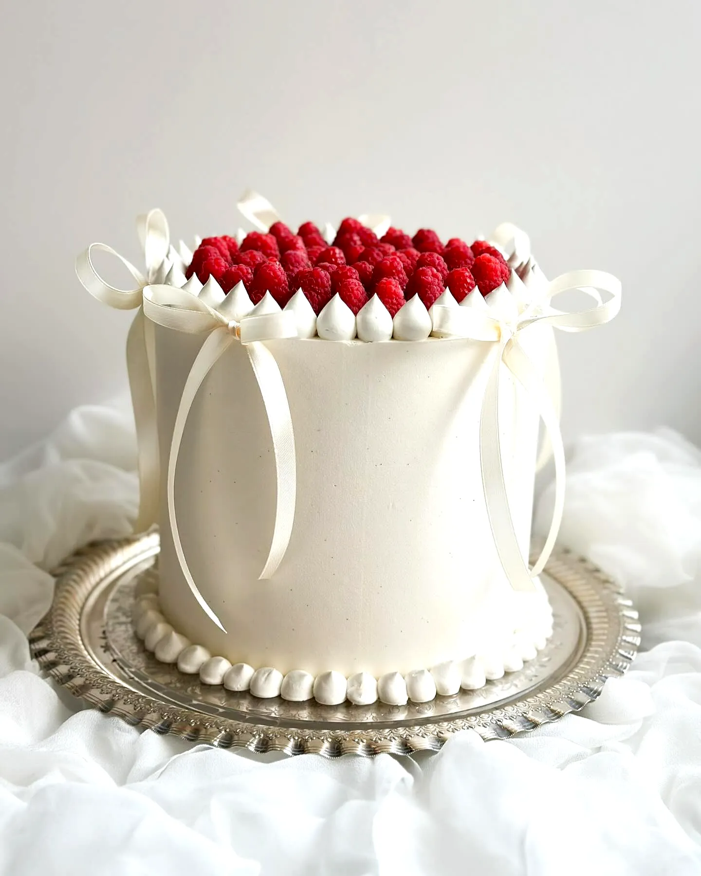 Elegant Wedding Cake Design with Smooth Buttercream and Fresh Raspberries