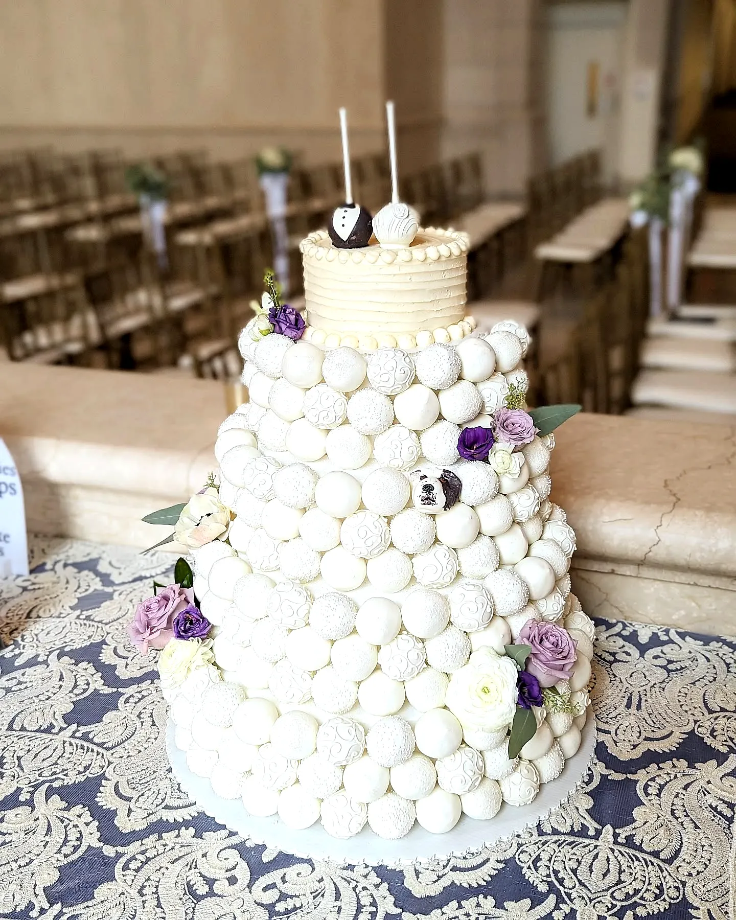 Elegant wedding cake pop design in white with colorful floral accents