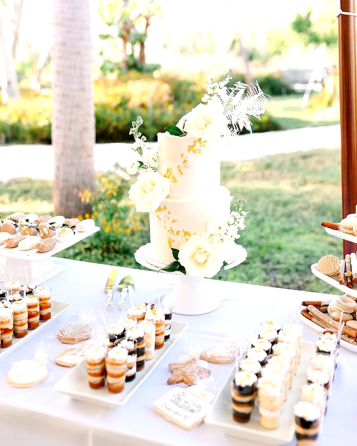 Elegant Wedding Cake Table Design with Golden Floral Patterns and Sugar Flowers