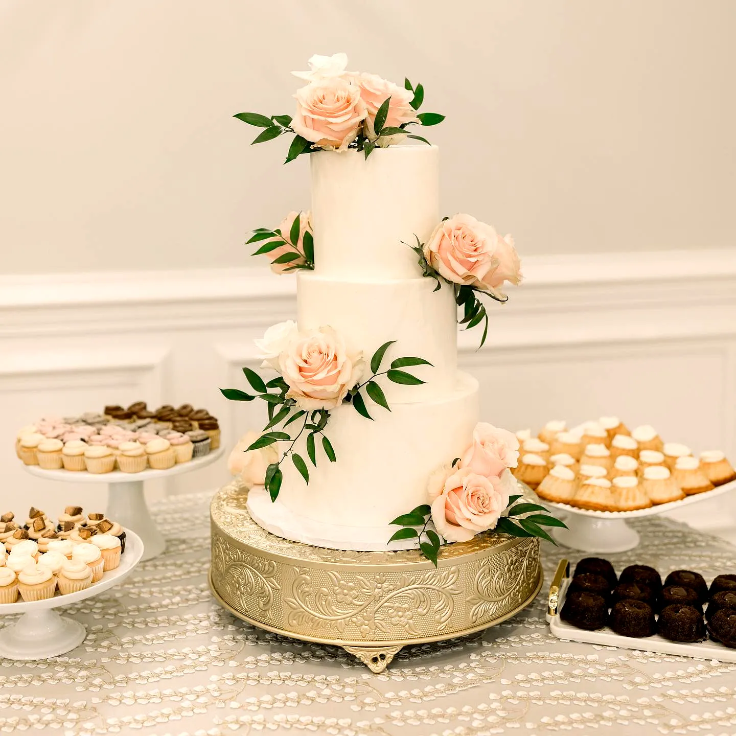 Elegant wedding cake table design with romantic floral accents