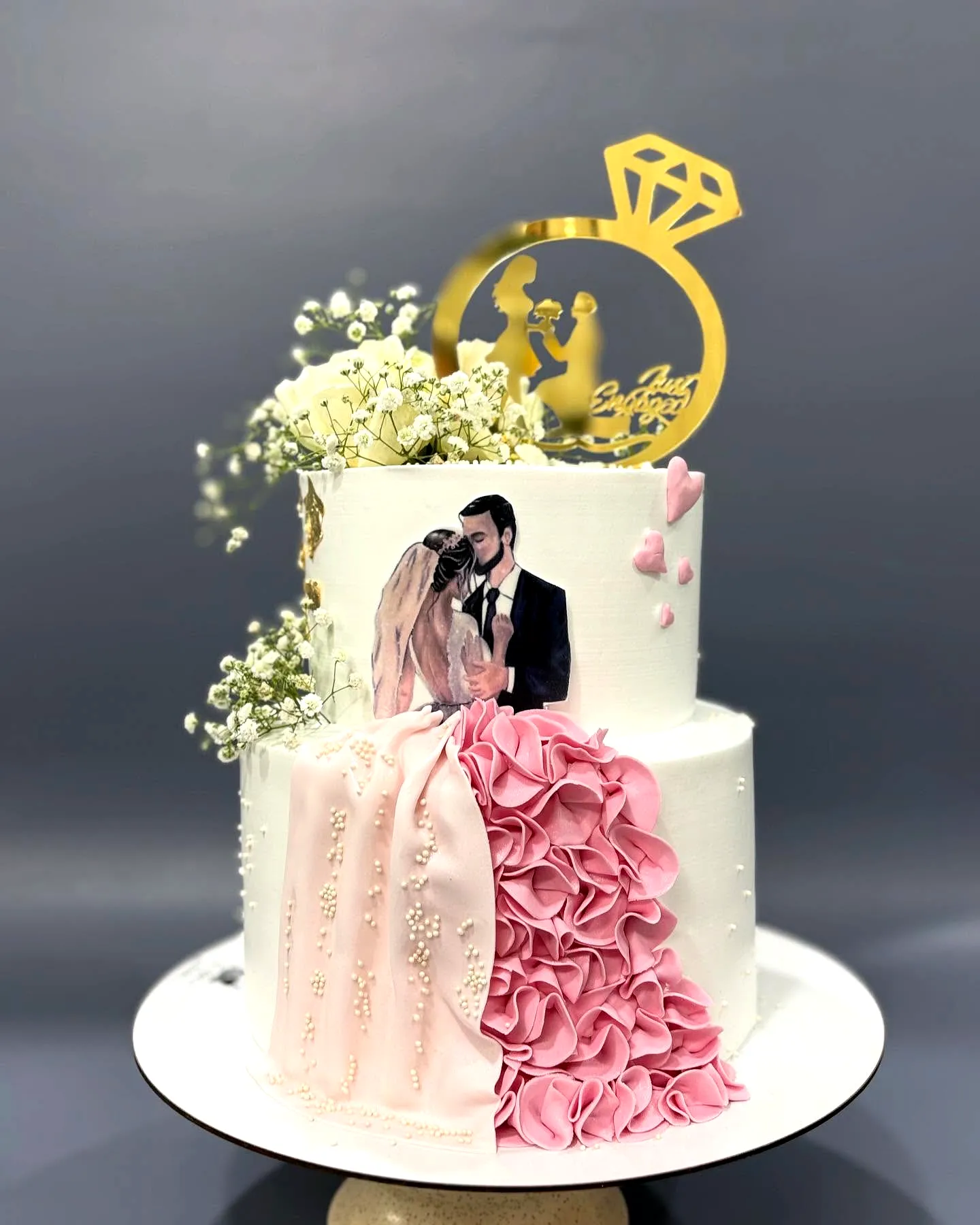 Elegant wedding cake with romantic pink ruffles and floral accents