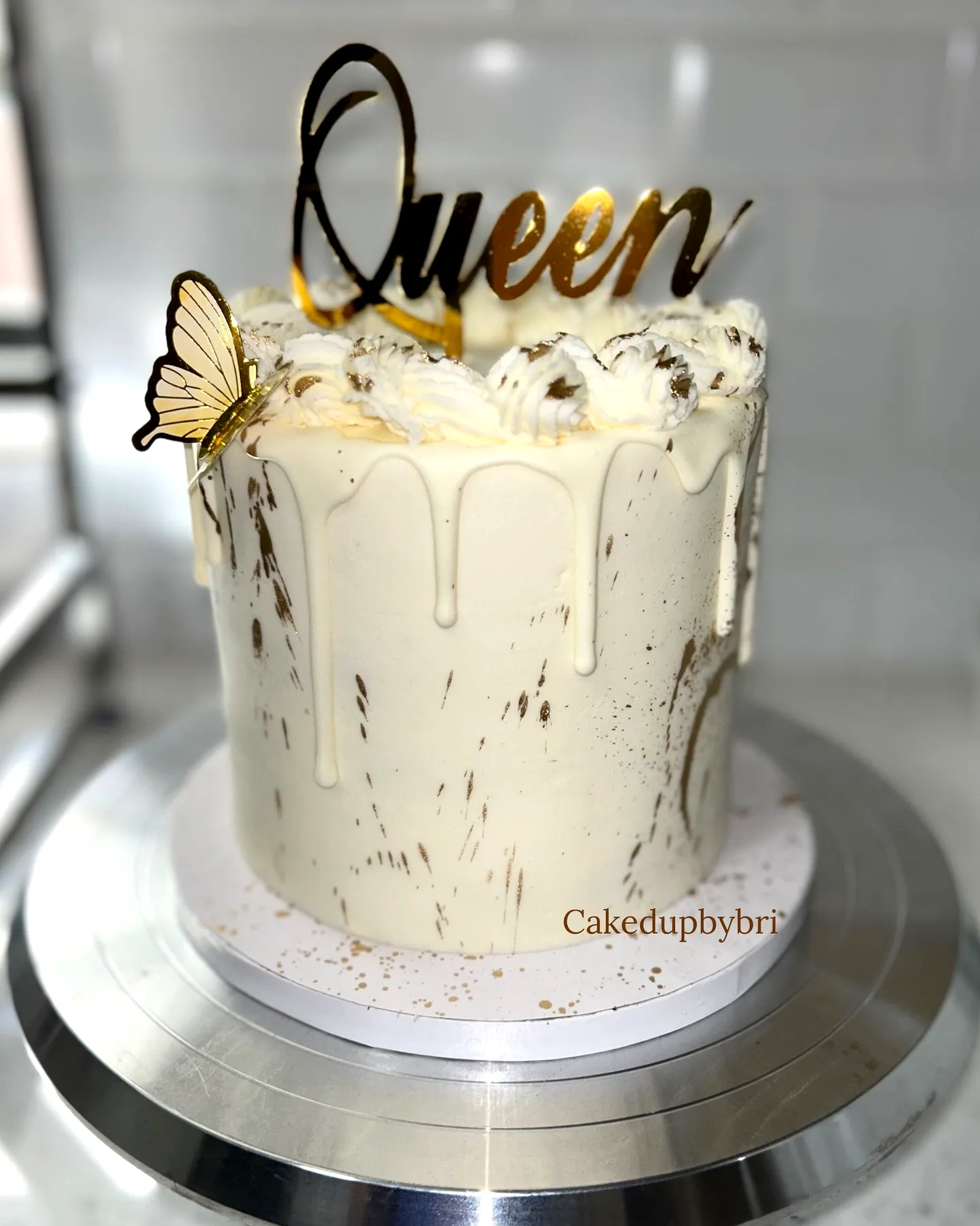 Elegant White Birthday Cake Design with Gold Drip and Butterfly Decor