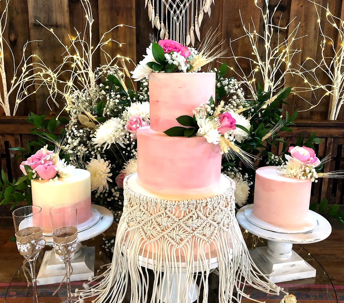 Lovely boho wedding cake design with pink ombre and fresh floral accents