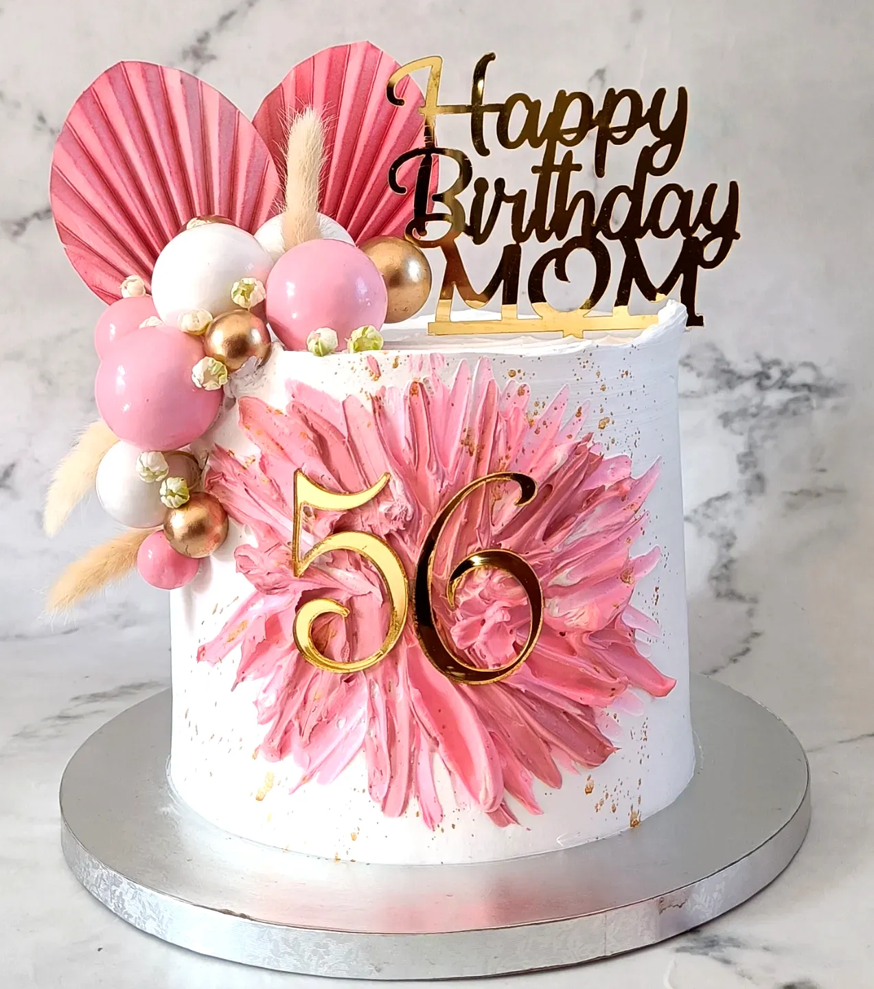 Lovely ladies birthday cake with vibrant pink florals and gold accents
