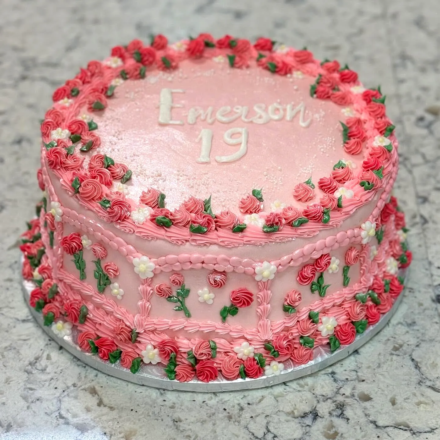Lovely pink 19th birthday cake design with floral decorations and intricate frosting