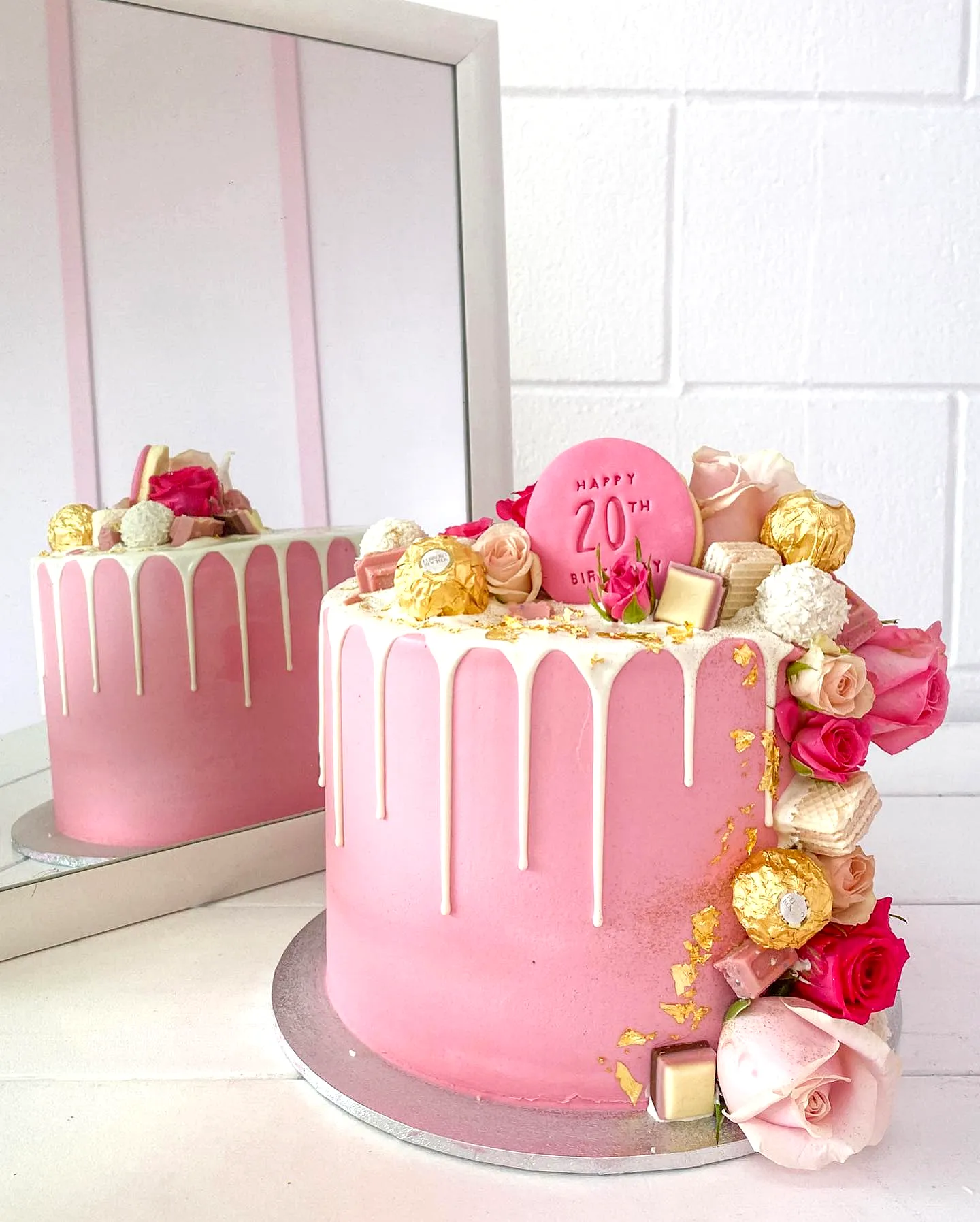 Lovely pink buttercream 20th birthday cake with elegant drip and decorations