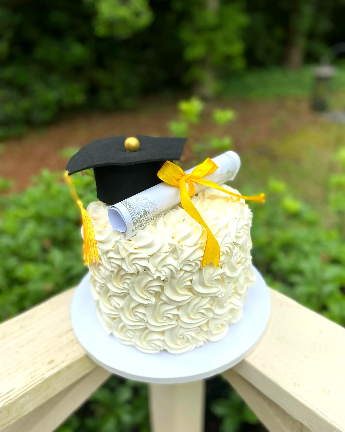 Simple graduation cake with a stylish swirl design and fun decorative elements