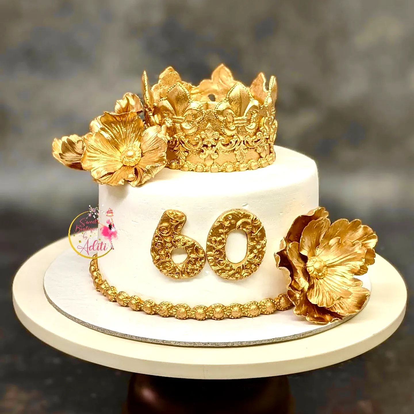 Stunning 60th Birthday Cake with Elegant Golden Crown and Floral Decorations