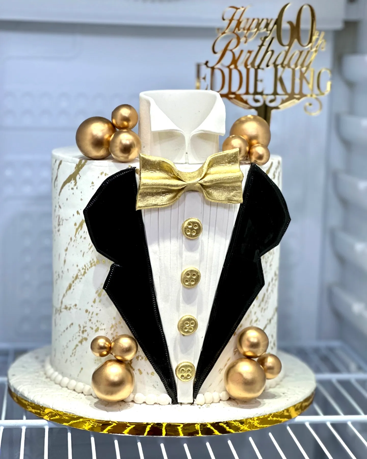 Stylish 60th Birthday Cake for a Man Featuring Tuxedo Design and Gold Accents