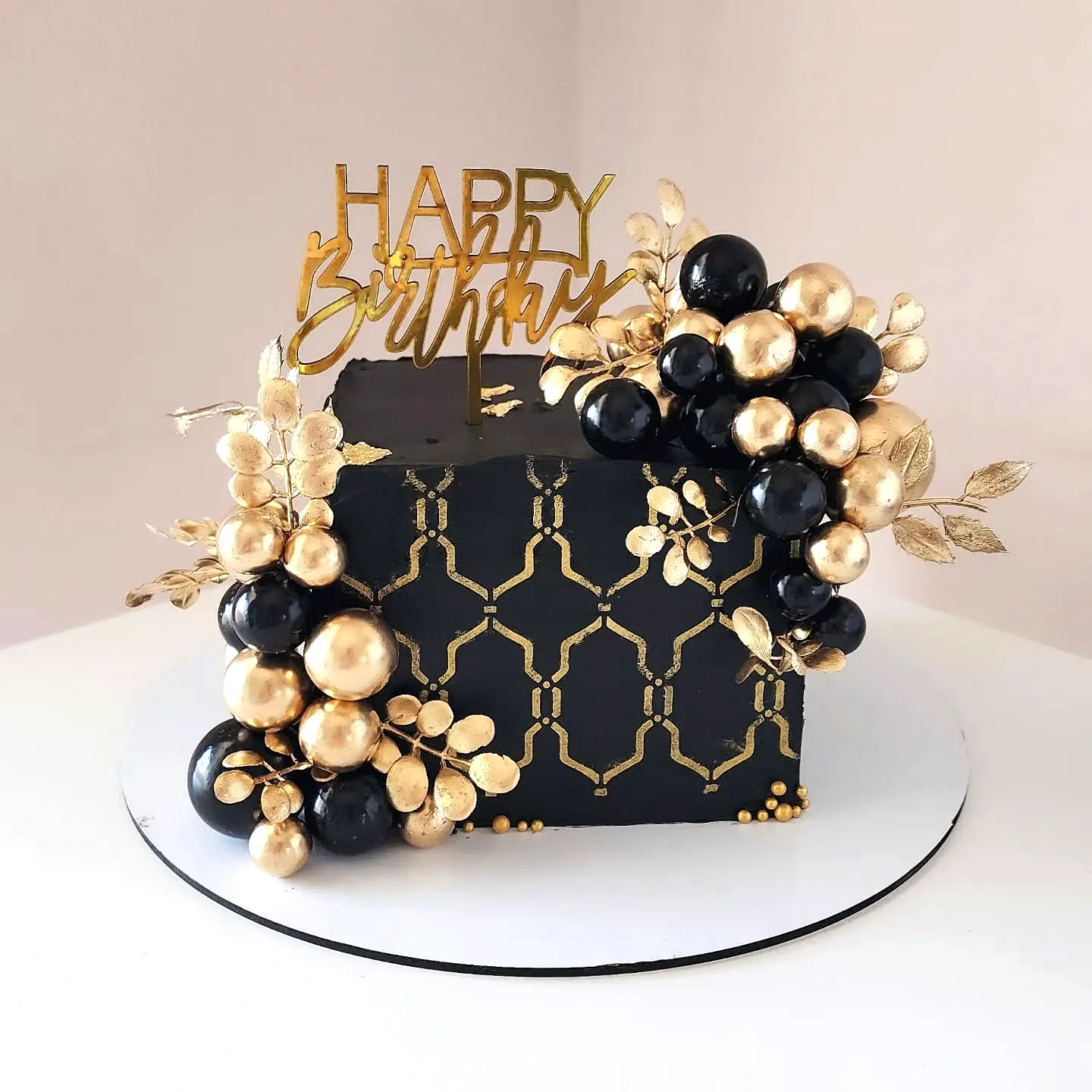 Stylish Black and Gold Birthday Cake for an Elegant Celebration