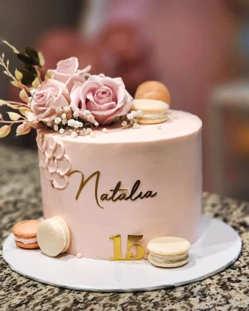 Trendy 15th Birthday Cake Design with Pink Buttercream and Floral Elegance