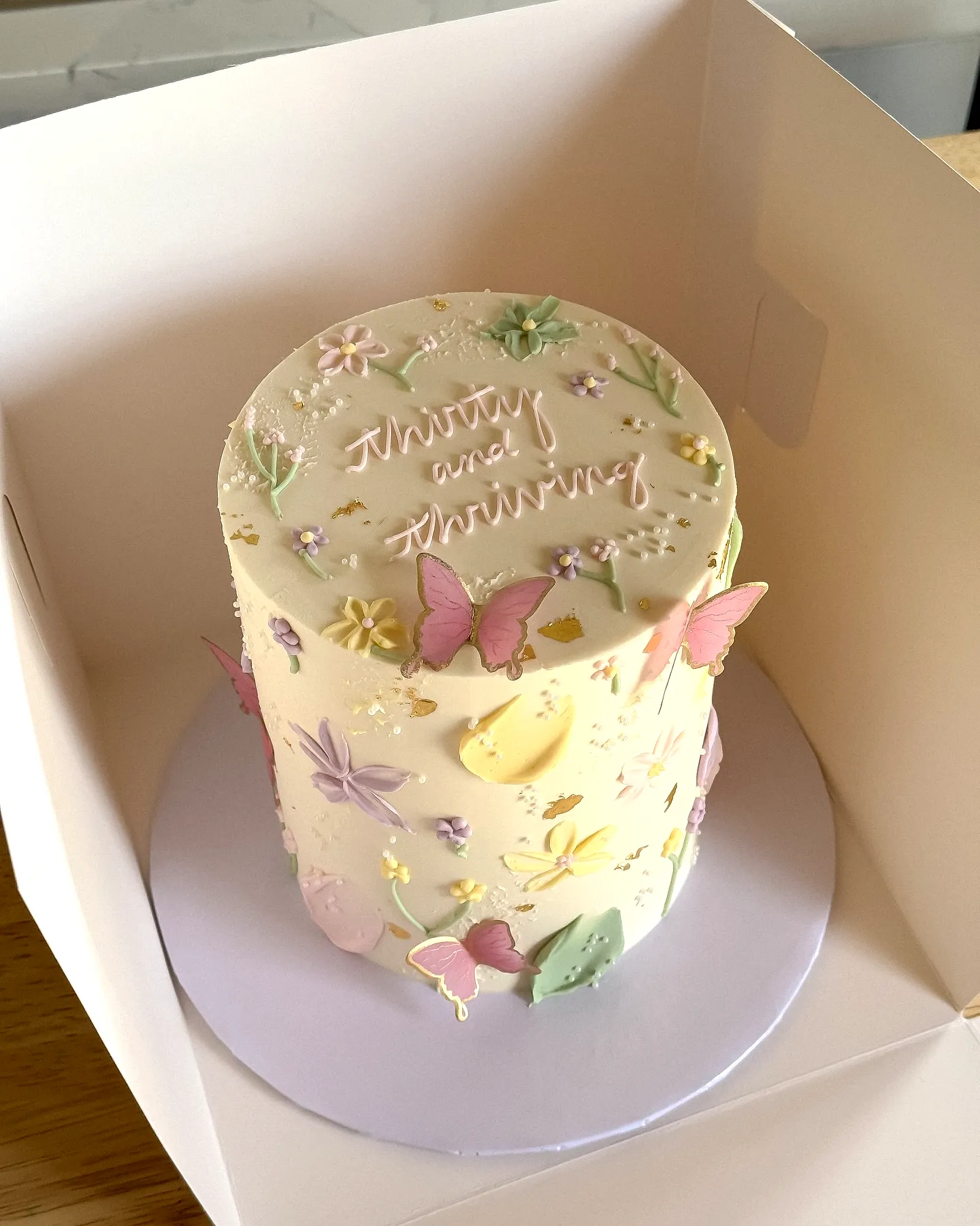 Whimsical Birthday Cake for Women with Pastel Flowers and Butterflies