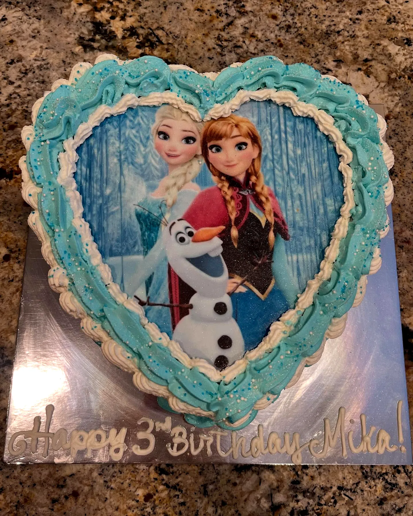 Whimsical Heart-Shaped Frozen Birthday Cake with Colorful Frosting and Sprinkles