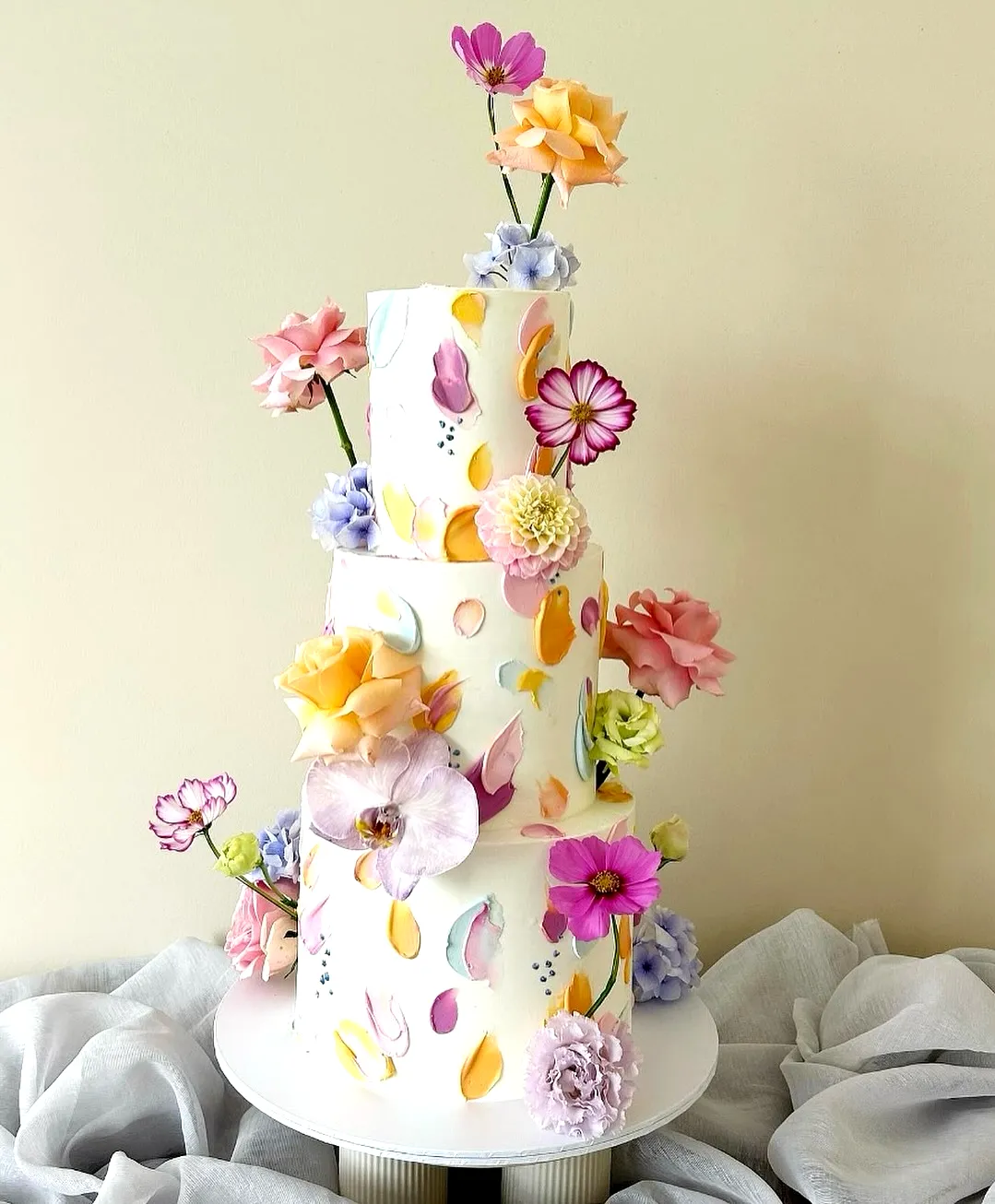 Whimsical Wedding Cake Design with Colorful Hand-Painted Petals and Flowers