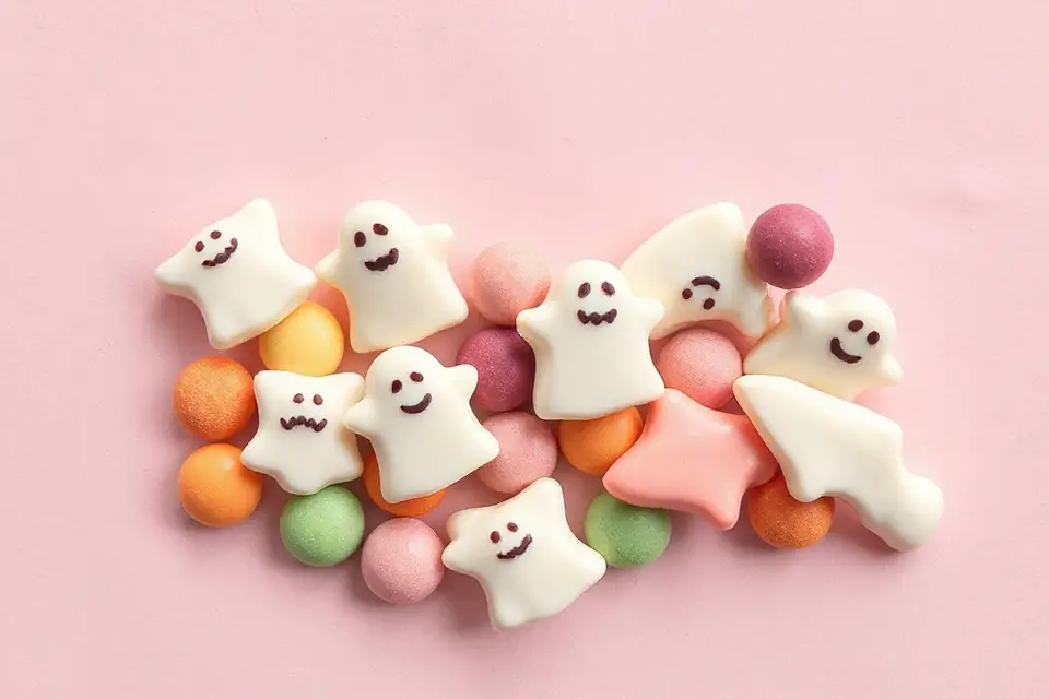 ghost shaped candies on pastel