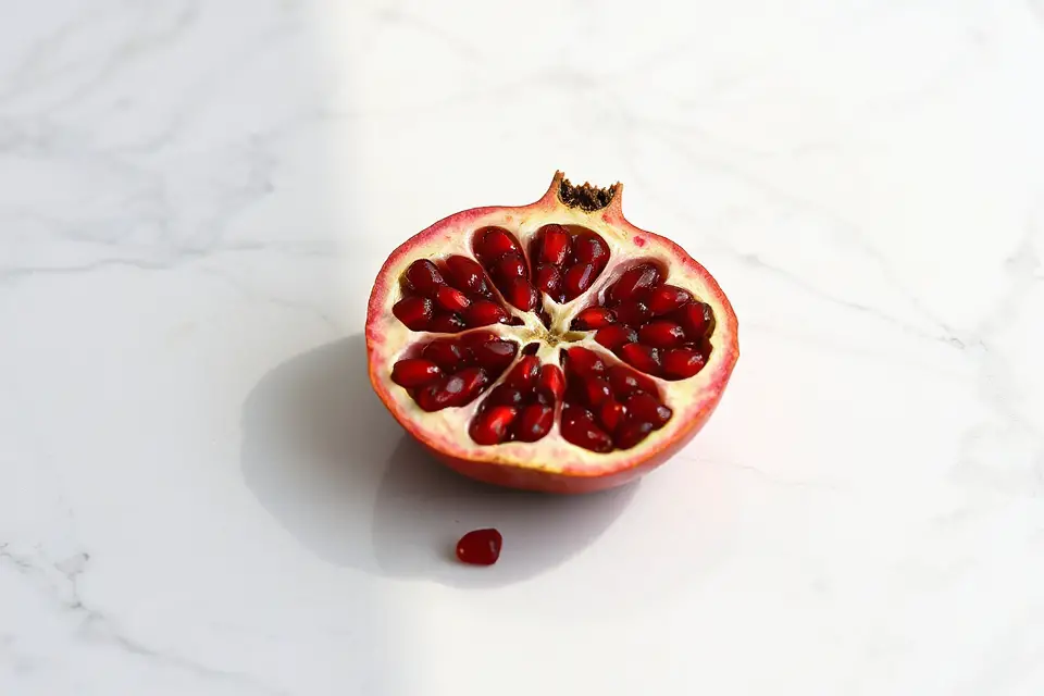 halved pomegranate on marble